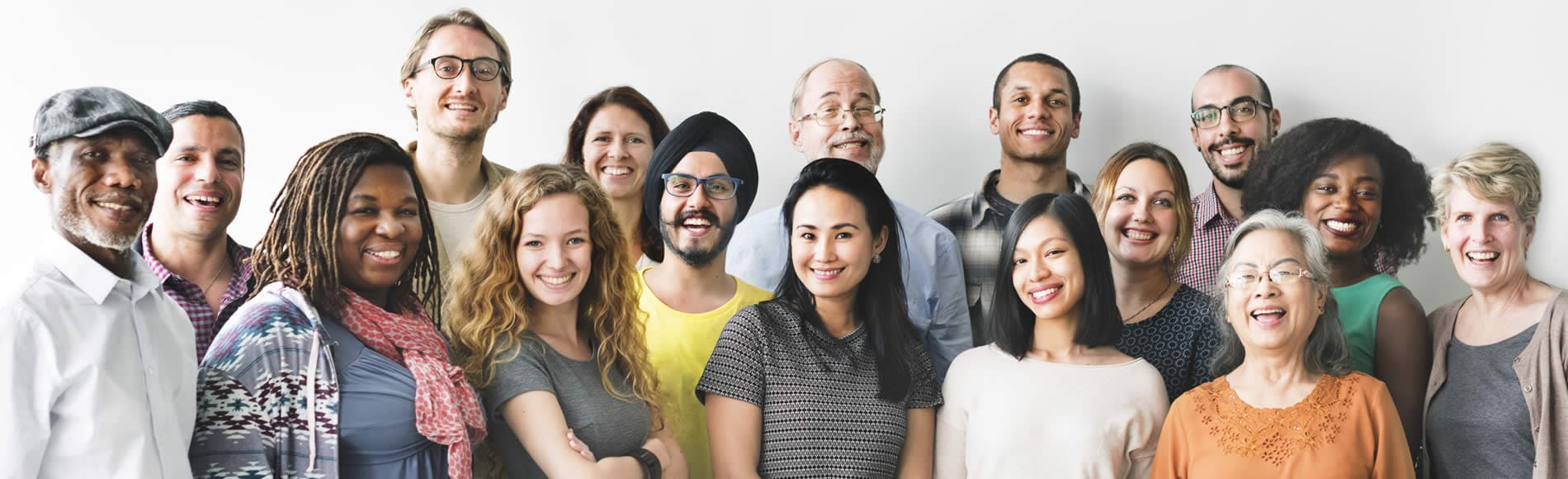 Group of multi-ethnic market research respondents standing smiling against a white background
